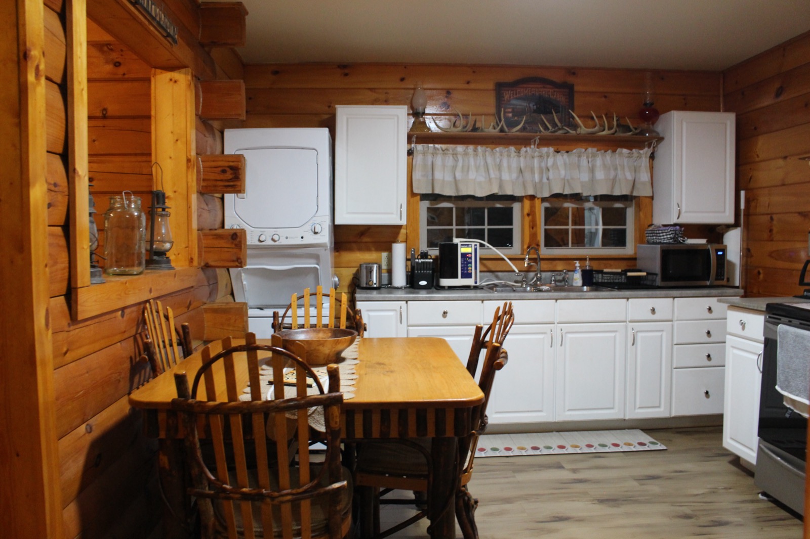 Dining table with kitchen and laundry visible
